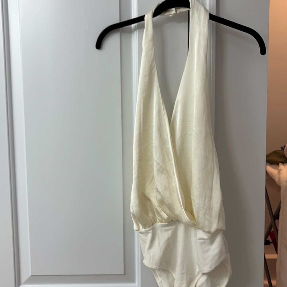 Halter Neck low cut body suit. Never worn still has tags ! Cream color